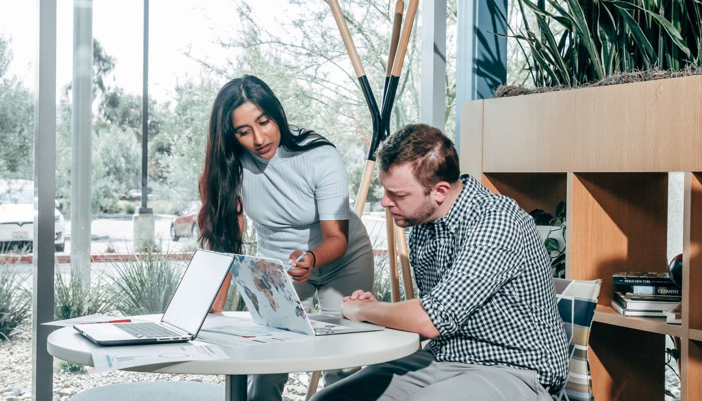 A couple comparing health coverage options on a laptop at home